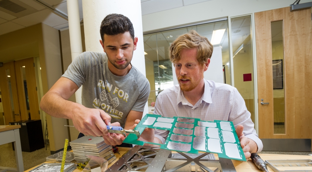 The Lincoln Scholars Program allows full-time graduate study at a local university. Above, the scholars attach panels to Boston University's first CubeSat and continue their Laboratory work in satellite aerodynamics.