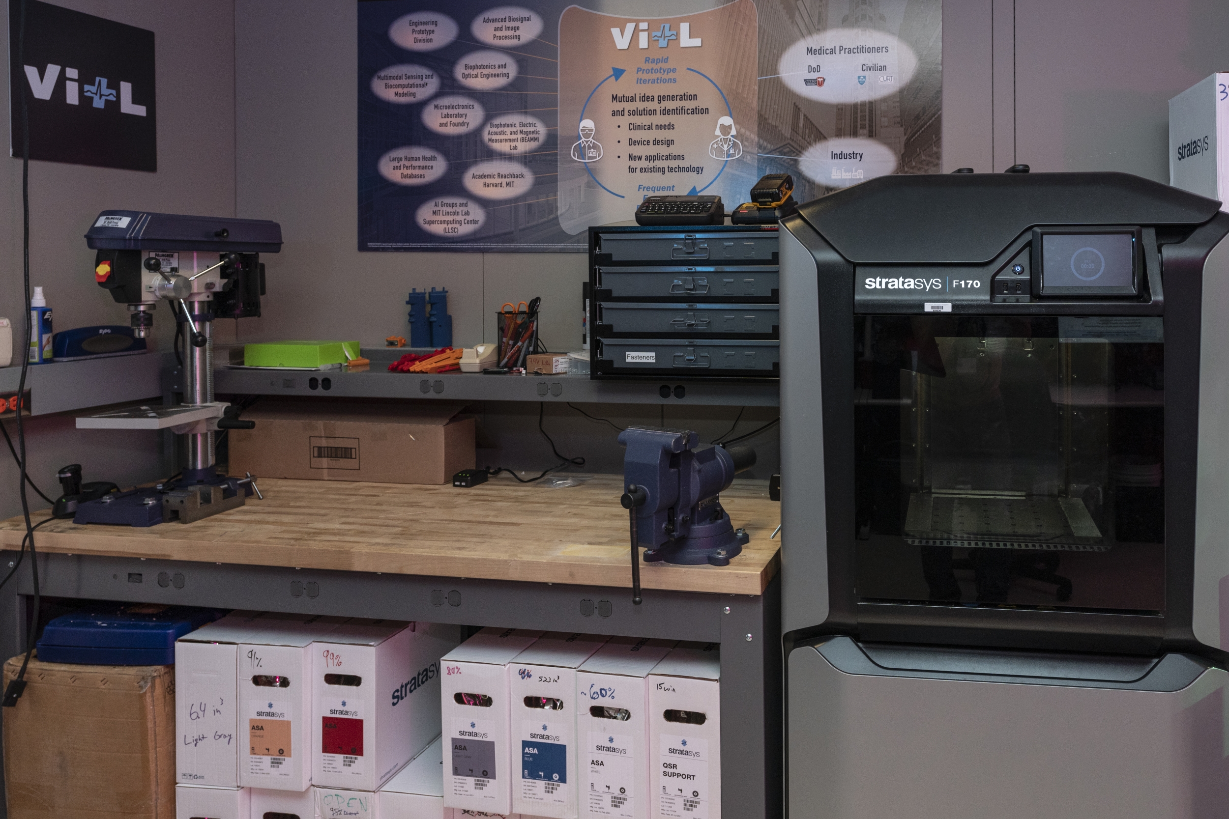 an image inside of the VITL lab showing a mechanical assembly bench and a large 3D printer. 