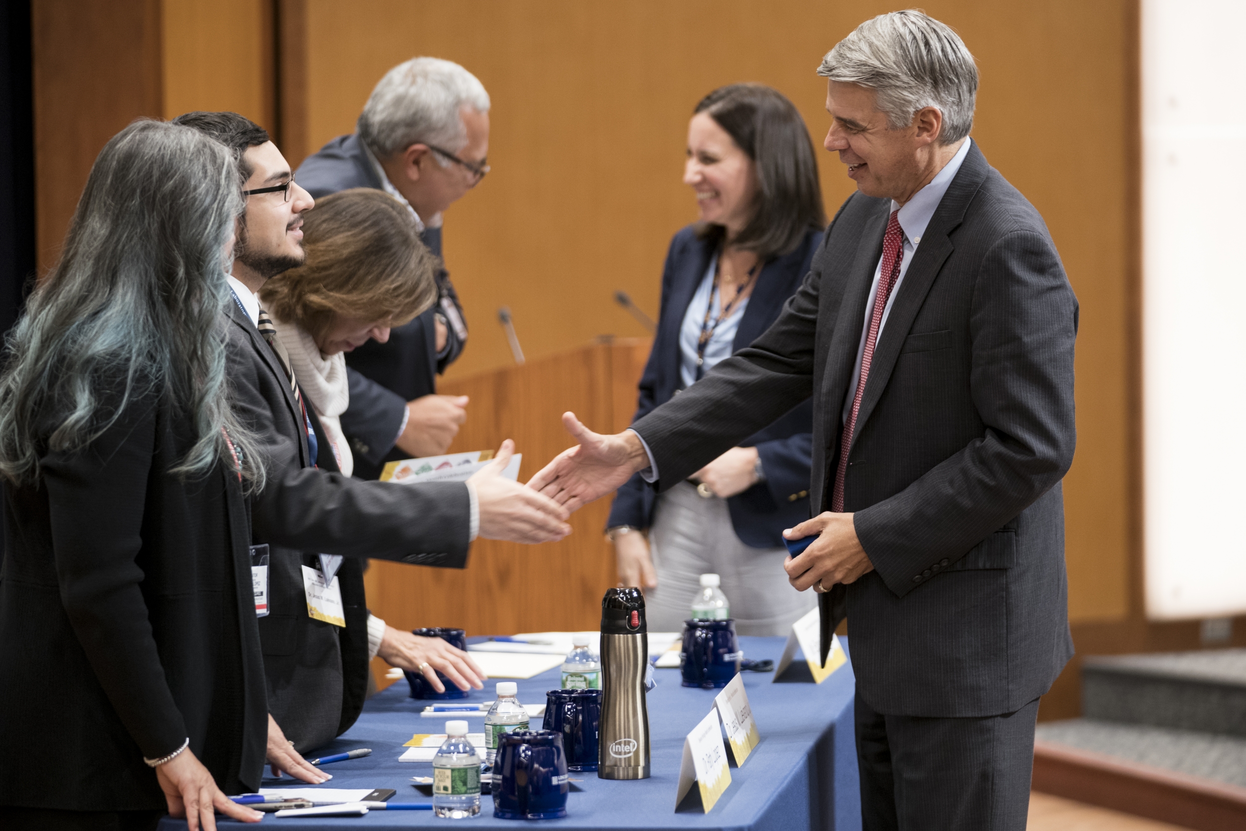 Eric Evans, right, greets panelists, from left to right, Patty Lopez, Jesus Luevano Jr., Alicia Juarrero, and Edgar Quintero. Also pictured, Mabel Ramirez. Photo: Glen Cooper