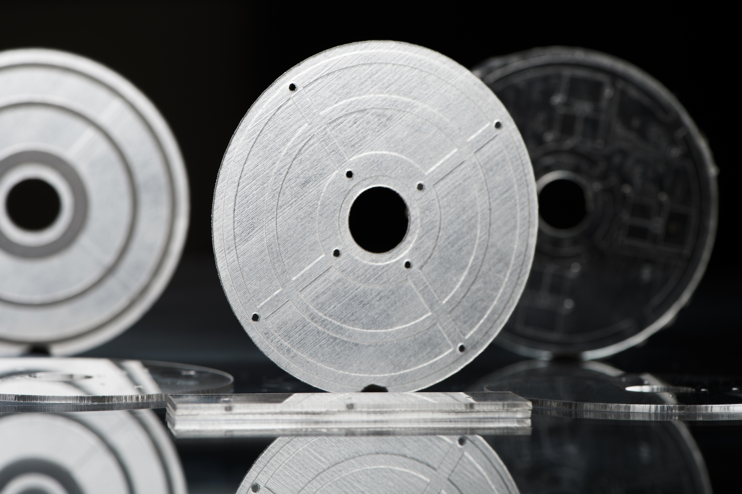 three disc-shaped microfluidic device that were 3D printed