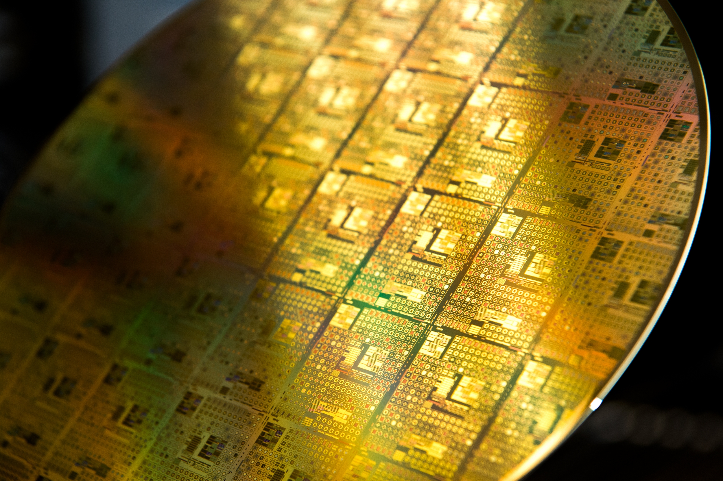 A photo of gold-colored integrated circuit wafer.