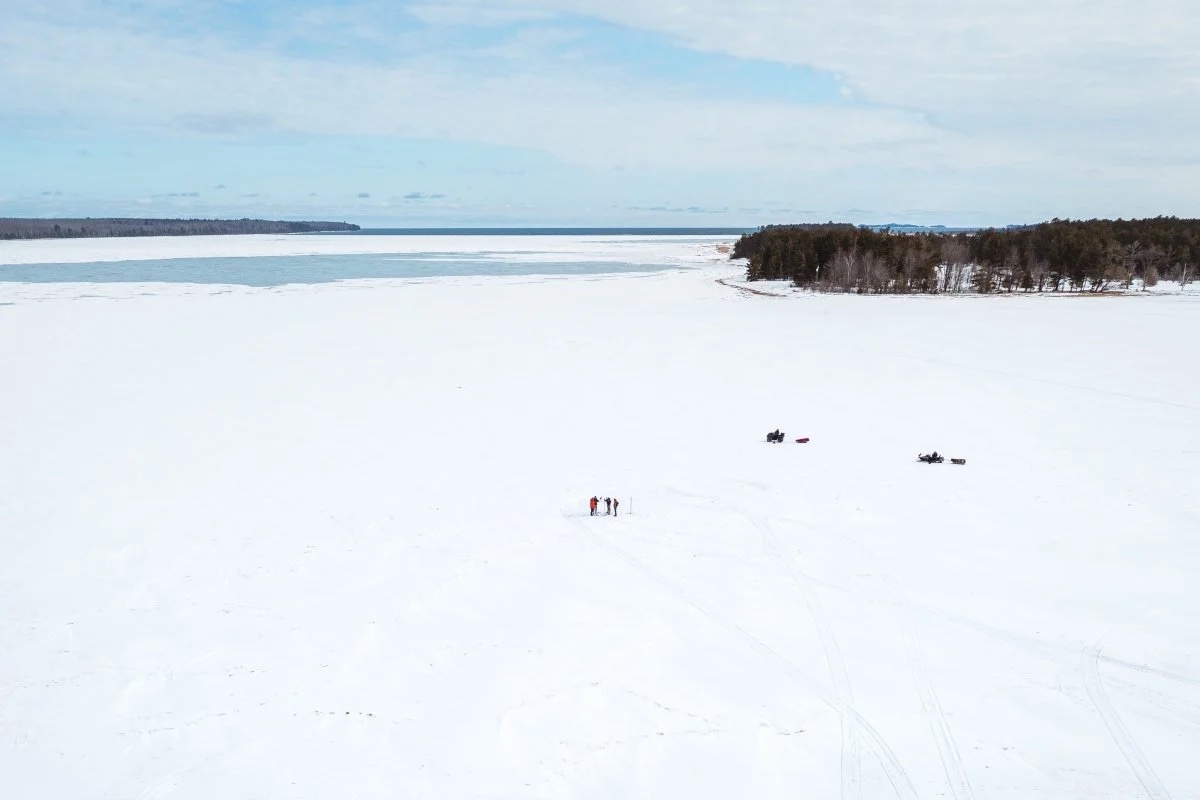 People gather on large sheet of ice. 