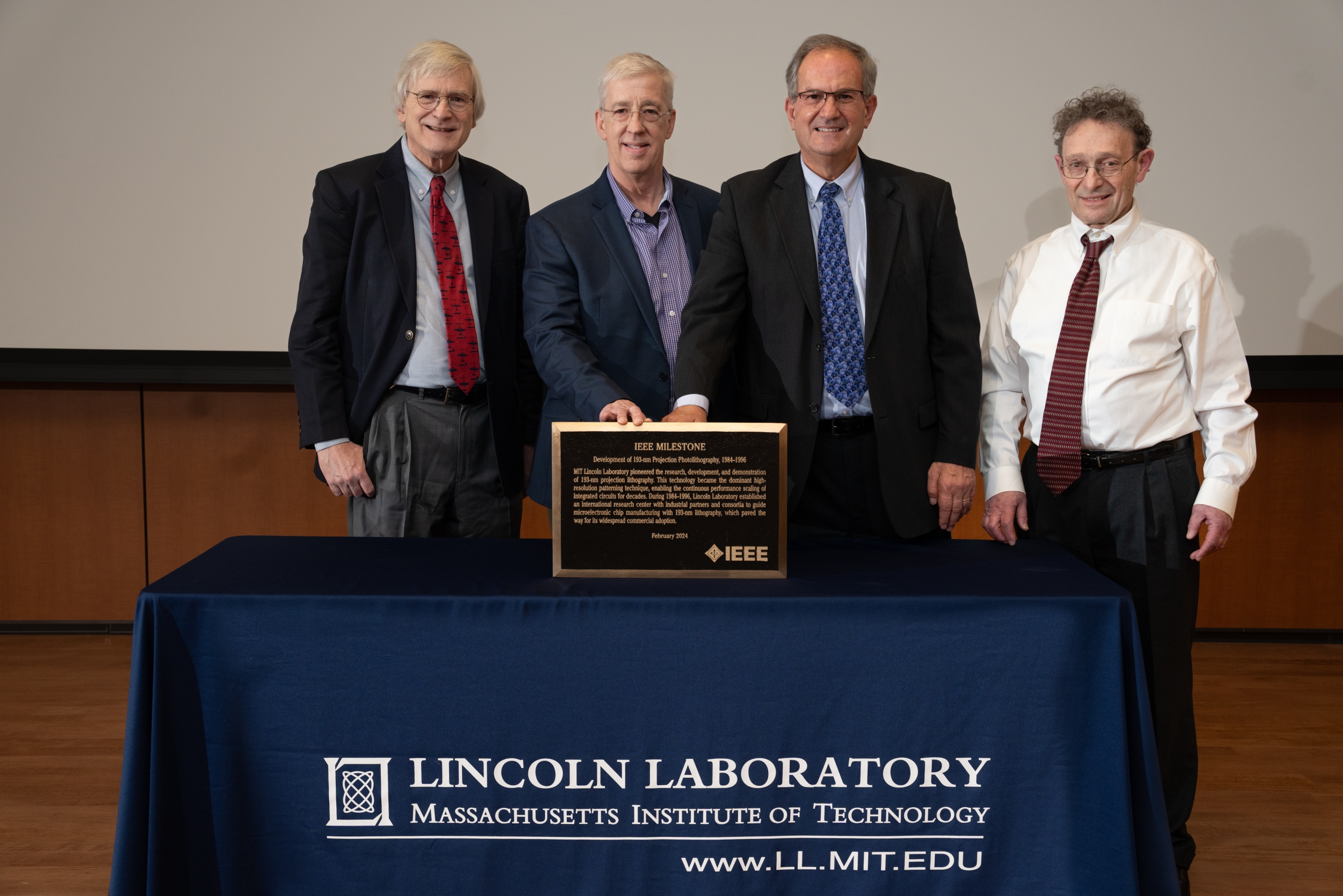 Alan Shaver, Dan Corliss, Craig Keast, and Mordechai Rothschild are pictured with the 193 nm photolithography plaque.