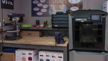 an image inside of the VITL lab showing a mechanical assembly bench and a large 3D printer. 