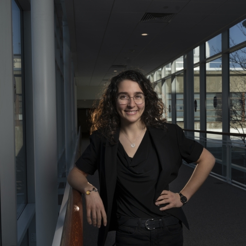 A photo of Ariel Sandberg in the walkway by the Laboratory lobby.