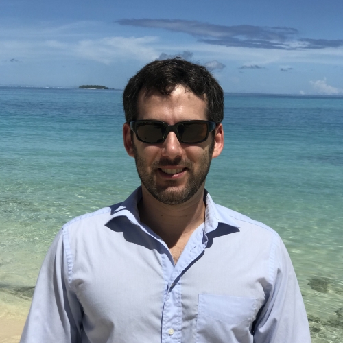 Andrew Mack in front of a beach on the Kwajalein Field Site