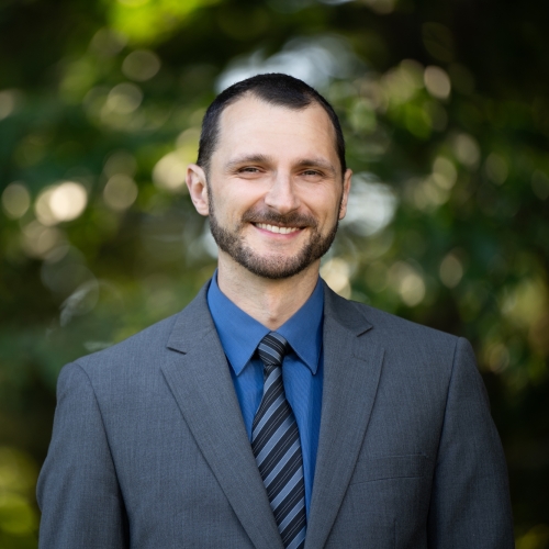 An outdoor portrait photograph of Vitaliy Gleyzer.