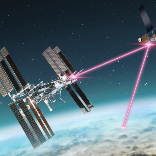 A schematic of a laser communications terminal onboard the International Space Station transmitting data over laser signals to a smaller satellite at a higher altitude; this satellite then relays the data to Earth.