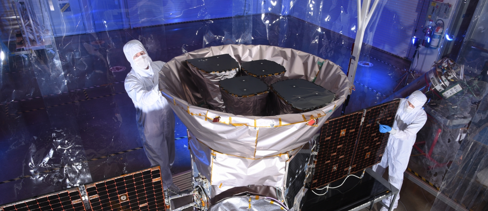 Staff from the Laboratory and the aerospace company Orbital ATK inspect the satellite in Dulles, Virginia, prior to shipment to the Kennedy Space Center for launch vehicle integration. The four cameras can be seen inside the sunshade. Photo: Orbital ATK