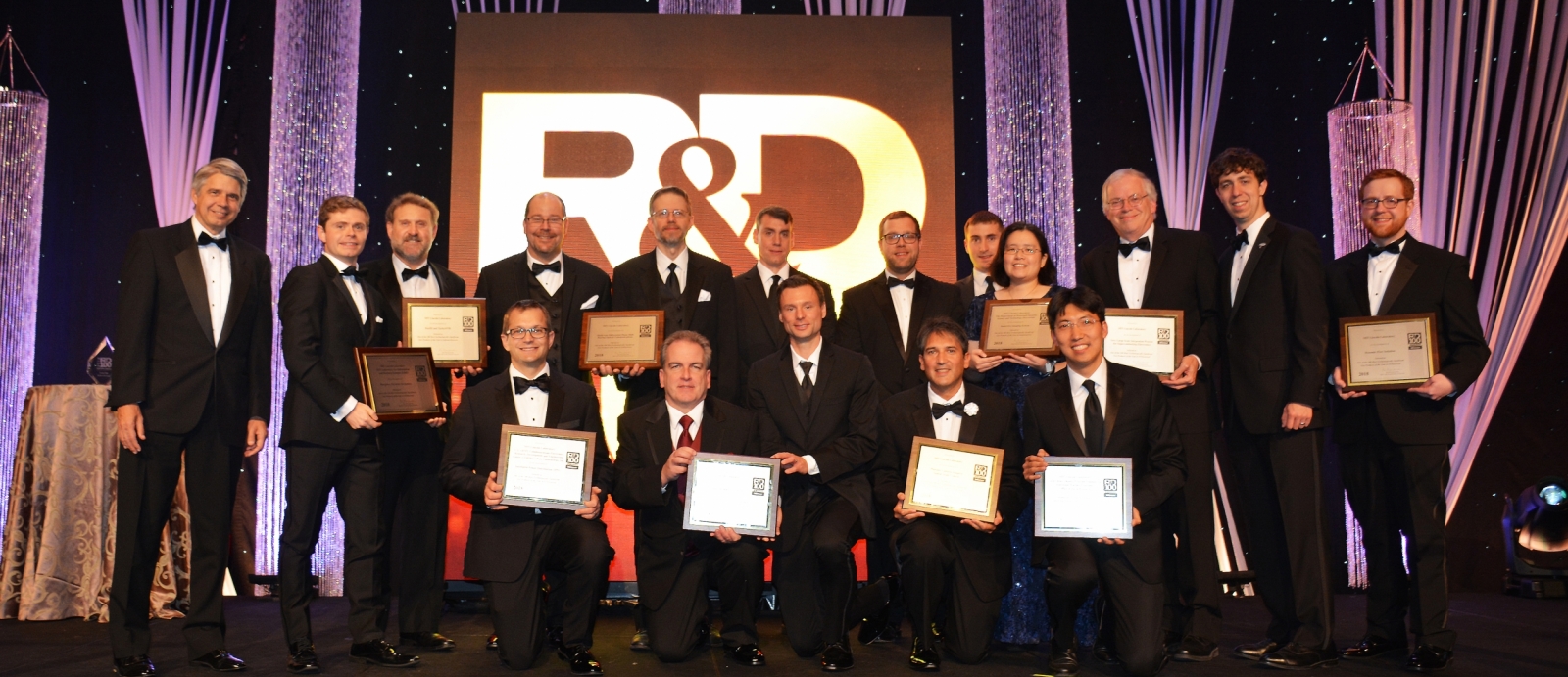 The principal researchers of MIT Lincoln Laboratory's 12 finalists for 2018 R&D 100 Awards are pictured here with Lincoln Laboratory Director Eric Evans (far left). The principal researchers of the 10 winning technologies hold up their award plaques. 