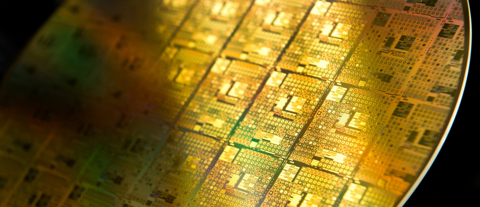 A photo of gold-colored integrated circuit wafer.