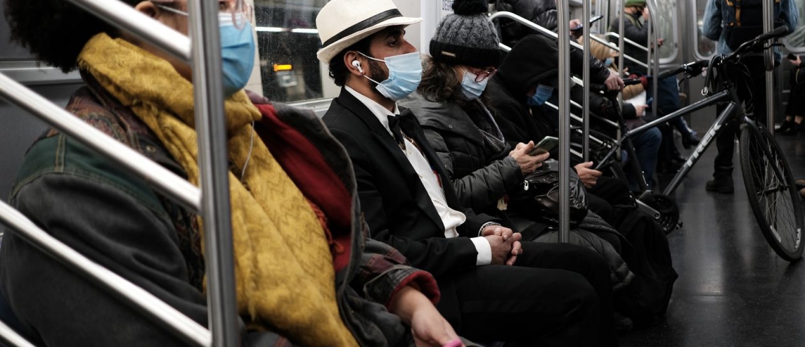 An image of riders on a subway train
