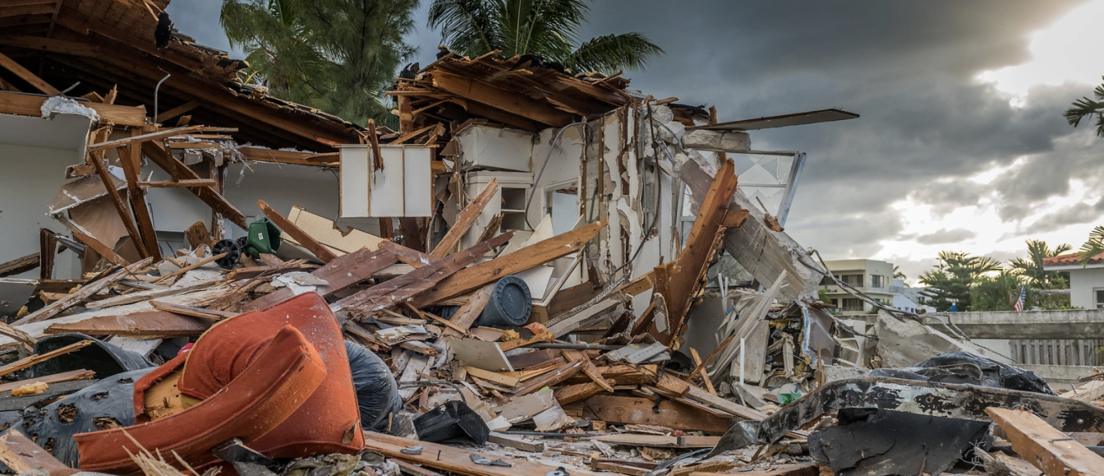A house is shown destroyed and reduced to rubble.