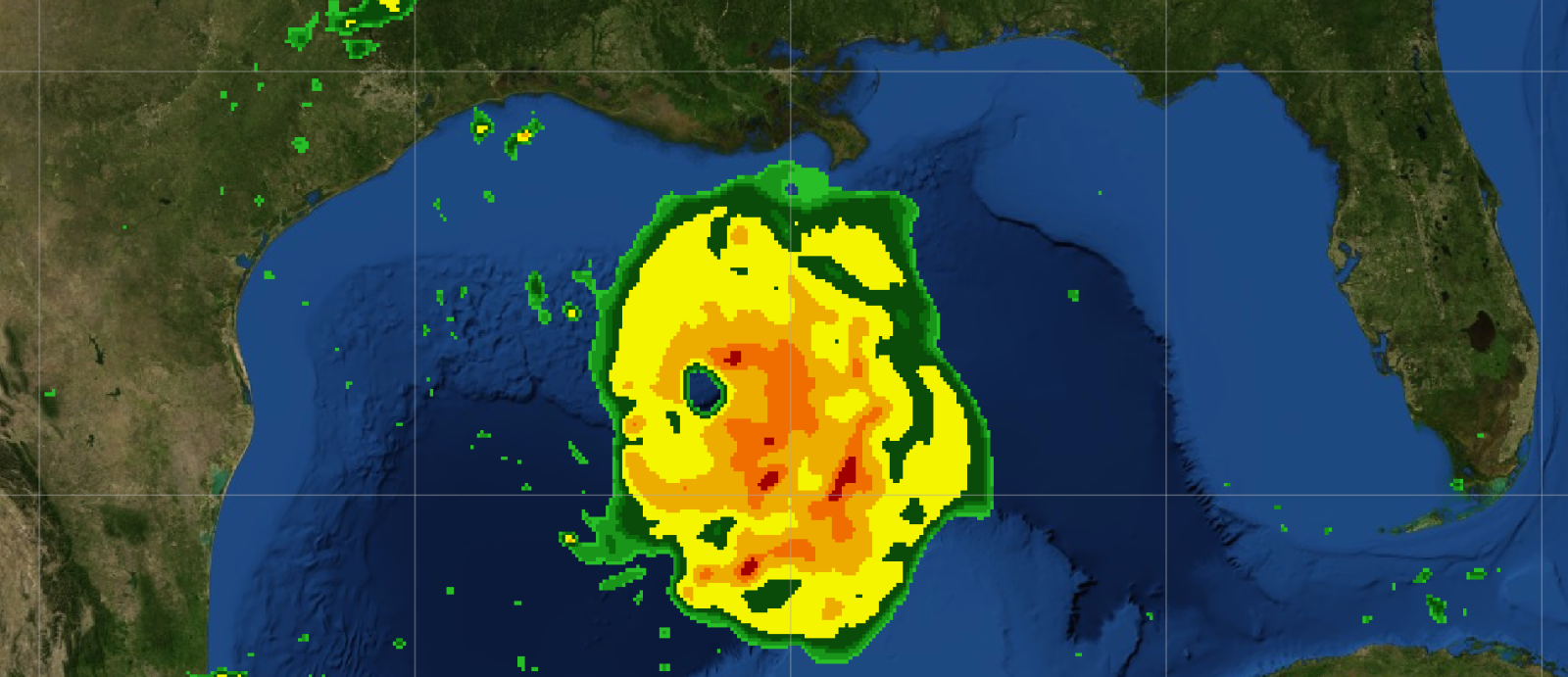 A radar-like image showing a large hurricane in the gulf of mexico. The storm is colored by rain/intensity, showing green bands on the outside, and yellow and orange in the interior. The water is blue and the nearby land is green.