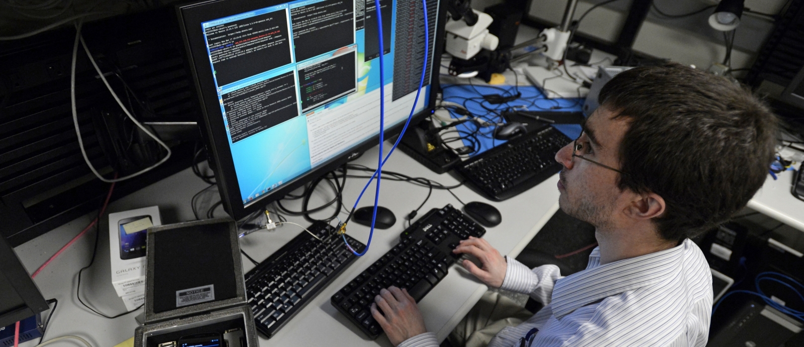 In the mobile device laboratory, a researcher in the Cyber Systems and Operations Group investigates the cyber-electromagnetic environment for handheld devices and wireless communication.