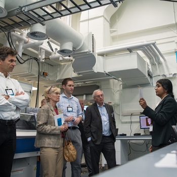 Lalitha Parameswaran of the Laboratory's Chemical, Microsystem, and Nanoscale Technologies Group explains some of the capabilities of the Defense Fabric Discovery Center to guests at the center's opening day event.