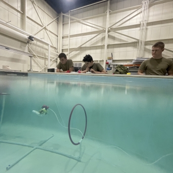 At the Laboratory's testing pool, cadets practice driving their vehicles through hoops placed underwater. 