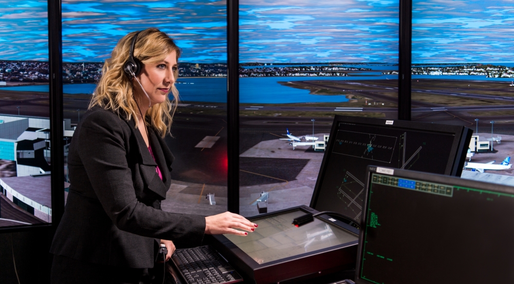 The facility's control tower simulator includes prototypes for surveillance, flight data collection, and traffic management decision support. Seen here, a Laboratory staff member controls aircraft at a simulated Boston Logan International Airport.