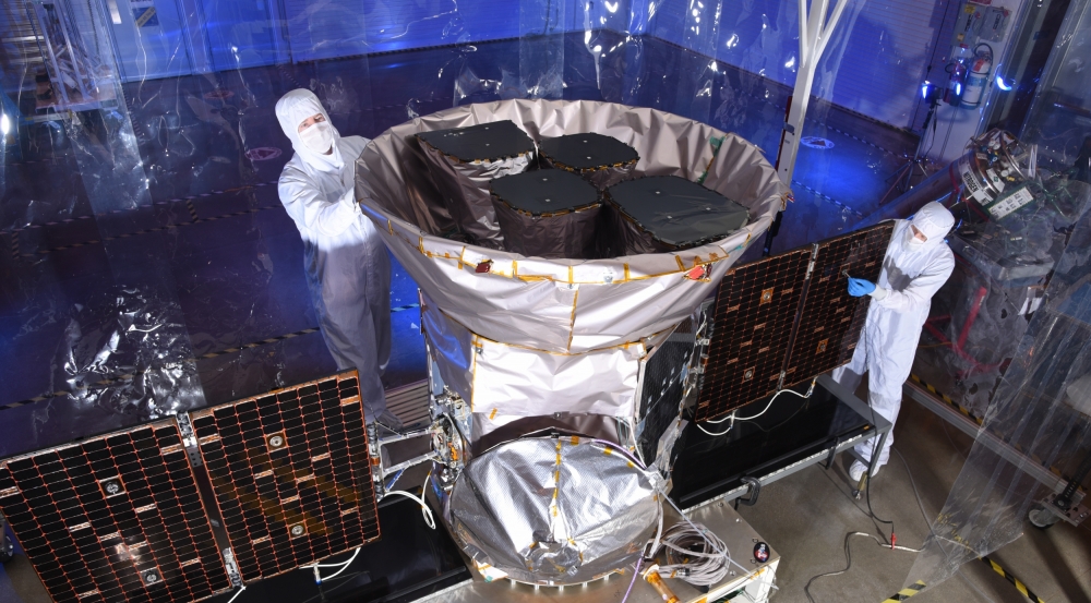 Staff from the Laboratory and the aerospace company Orbital ATK inspect the satellite in Dulles, Virginia, prior to shipment to the Kennedy Space Center for launch vehicle integration. The four cameras can be seen inside the sunshade. Photo: Orbital ATK