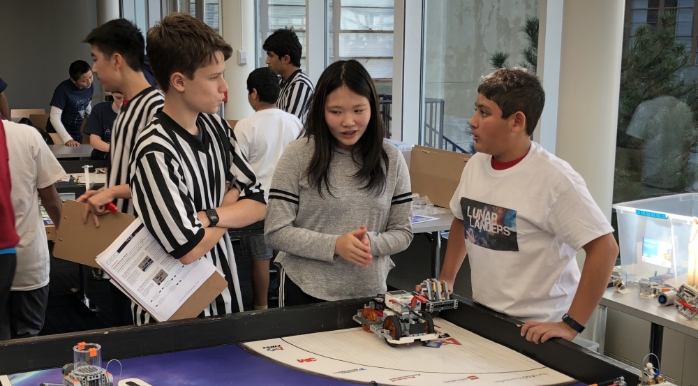 At a scrimmage in the main cafeteria, FIRST LEGO League teams (which consist of fourth to eighth graders) show each other their robots. They built the robots as part of the Robotics Outreach at Lincoln Laboratory program. Photo: David Radue