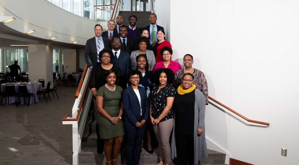 Eighteen members of the Martin Luther King Jr. Luncheon planning committee pose for a photo on a stairwell.