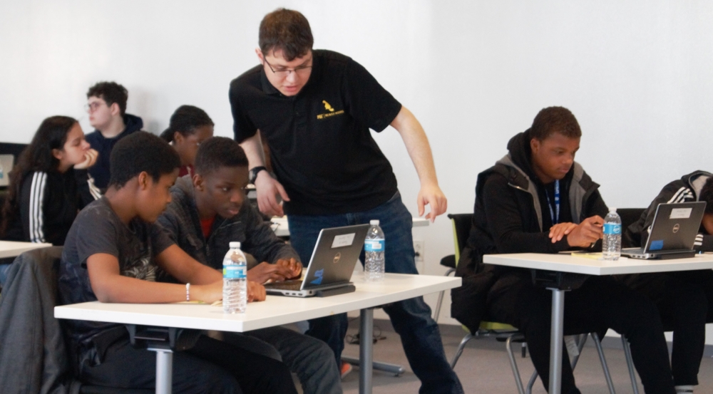 Andrew Fishberg checks on a student's progress. Photo: Madelaine Millar