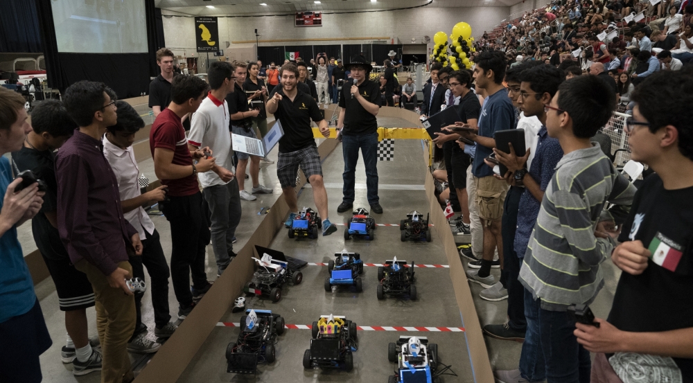 At the Beaver Works Summer Institute final event, teams of students prepare to race autonomous racecars around an obstacle course in the MIT Johnson Ice Rink. Photo: Glen Cooper