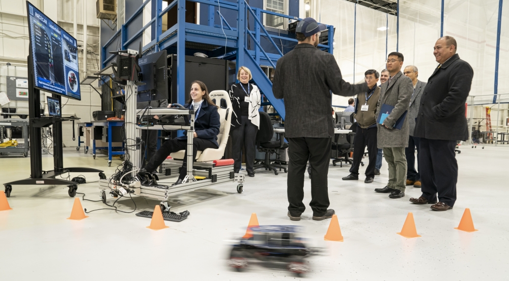 Attendees of the RAAINS workshop learn about the Laboratory’s RACECAR platform during a tour of the Autonomous Systems Development Facility.