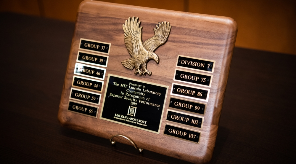 The plaque recognizing the 2019 Superior Security Rating issued to Lincoln Laboratory by the Air Force 66th Air Base Group Information Protection Office names the division and the 11 groups that participated in the 2019 security assessment.