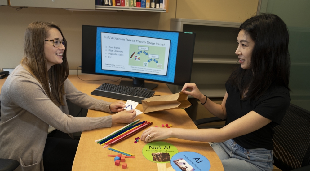 Olivia Brown (left) and Victoria Helus assemble kits for their artificial intelligence and machine learning workshops, offered through the Laboratory's Girls' Innovation Research Lab educational outreach program.