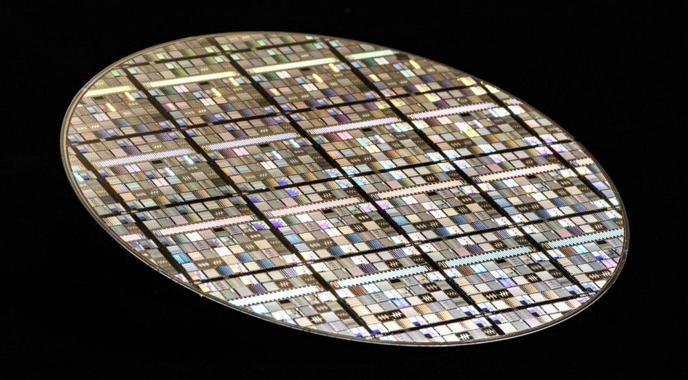 A photo of a microelectronics wafer, containing many circuits.