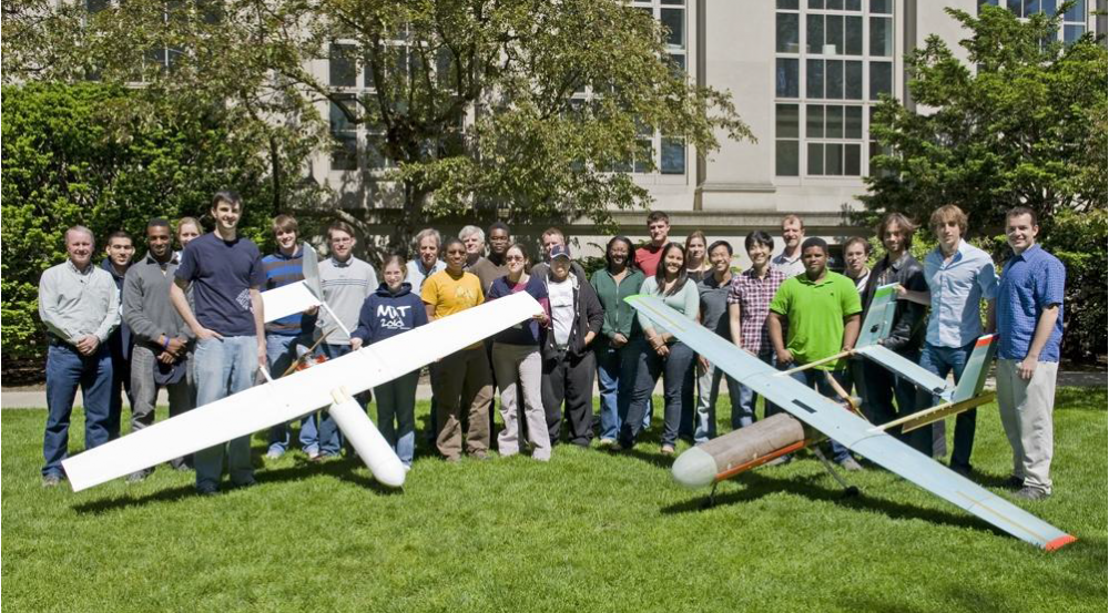 Photo of MIT students with UAVs they designed and built