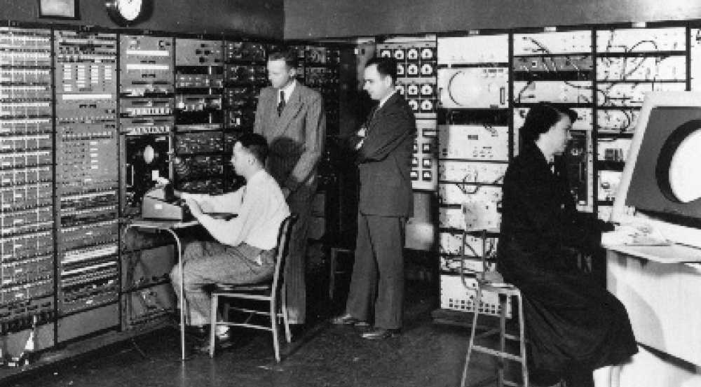 The Whirlwind computer console room in MIT's Barta Building in 1950; Jay Forrester, second from left, and Robert Everett, second from right.