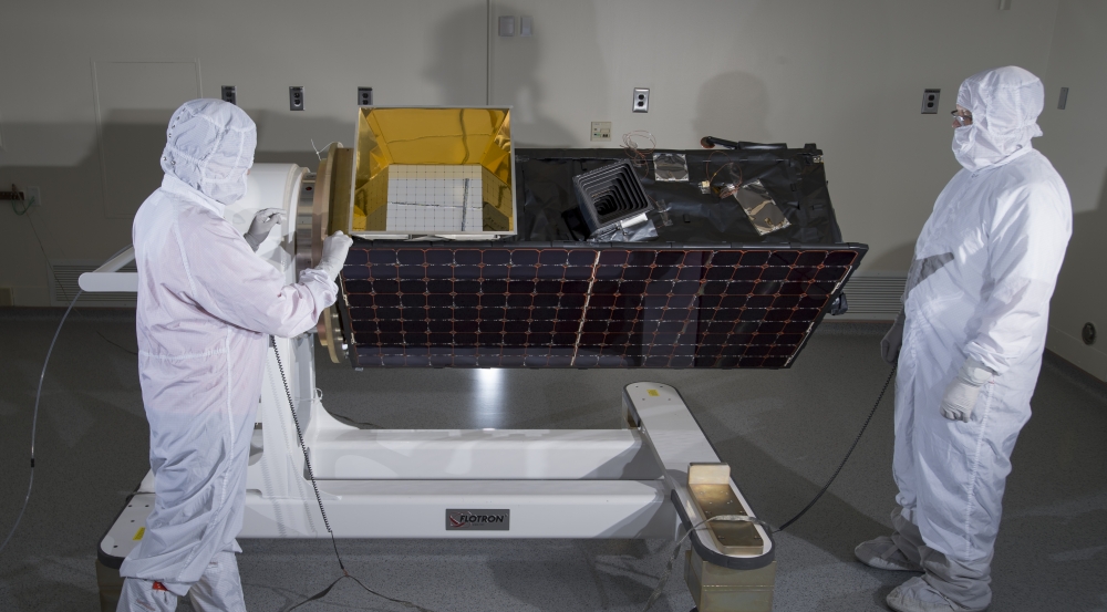 Engineers inspect SensorSat prior to thermal-vacuum testing that validated the system's endurance against the expected launch and space conditions.