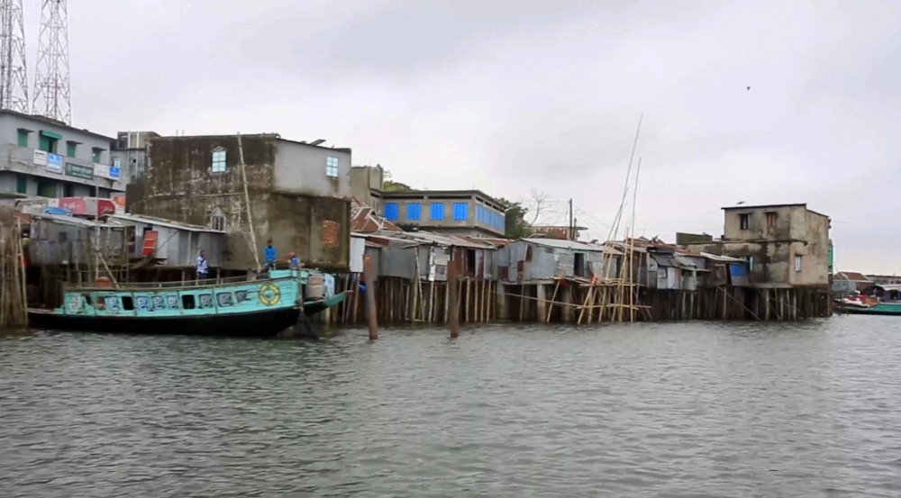 A photo of buildings built on piers over the ocean shore in Bangladesh 