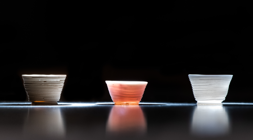 Researchers used the low-temperature additive manufacturing process to build the glass cups above.   The optical behavior of the printed cups can be tailored by altering the chemical components of the inks. 