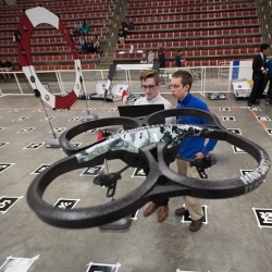 Students from the unmanned aerial vehicle course race their quadcopter through the obstacle course.