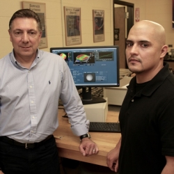 Dr. Nicholas Massa and student Gerald Gagnon in the Optics and Photonics laboratory at STCC.