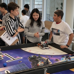 At a scrimmage in the main cafeteria, FIRST LEGO League teams (which consist of fourth to eighth graders) show each other their robots. They built the robots as part of the Robotics Outreach at Lincoln Laboratory program. Photo: David Radue
