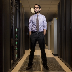 Vijay Gadepally stands in the supercomputing center 