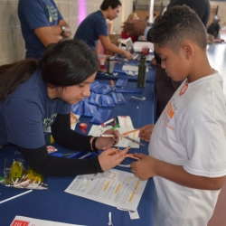 A Laboratory volunteer helps a student to construct a lightsaber. 