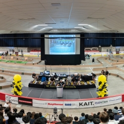 Robert Shin speaks to attendees of this year's Beaver Works Summer Institute final event with the RACECAR obstacle course in the background. Photo: Glen Cooper