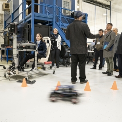 Attendees of the RAAINS workshop learn about the Laboratory’s RACECAR platform during a tour of the Autonomous Systems Development Facility.