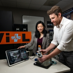 Research team members Matt Johnson and Laura Brattain test their new medical device on an artificial model of human tissue and blood vessels. (Photo credit: Nicole Fandel) 