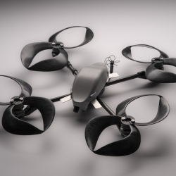 A small commercial drone outfitted with four toroidal propellers (each propeller looks like two loops, made of plastic).