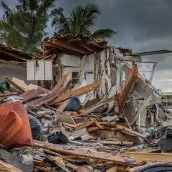 A house is shown destroyed and reduced to rubble. 