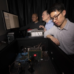 From left to right, Niyom Lue, Jonathan Richardson, and Tom Cheng test the detector in the laboratory.