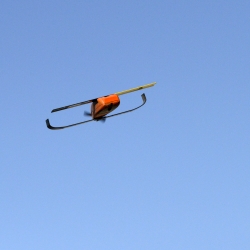 This miniature unmanned aerial vehicle is capable of autonomous navigation, including coordinated maneuvering within a large group of autonomous UAS.