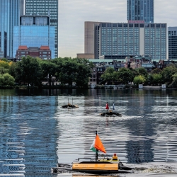 A photo of unmanned surface vehicles on the Charles River.