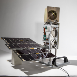 a photo of a small satellite in a studio